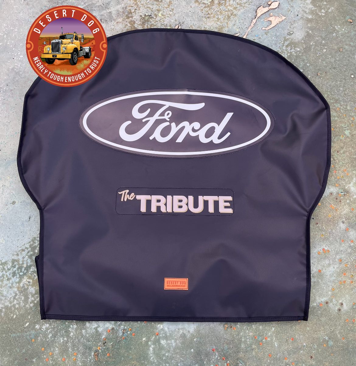 A custom Desert Dog turntable cover with the Ford logo and the truck name "The Tribute" printed on. The turntable cover is a Holland brand.