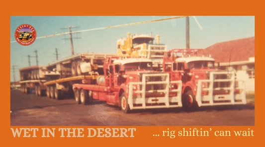 A fleet of trucks waiting for the Desert to dry out so they can move the rigs circa 1980