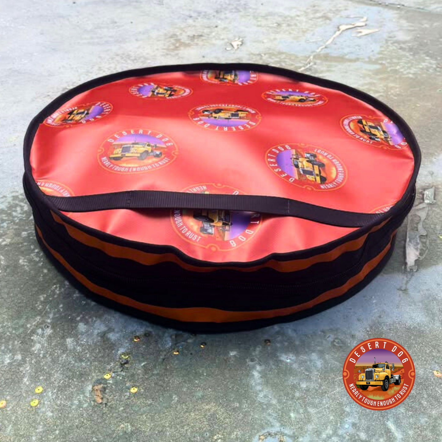 Rust coloured circular rope bag with logos and a zipped opening