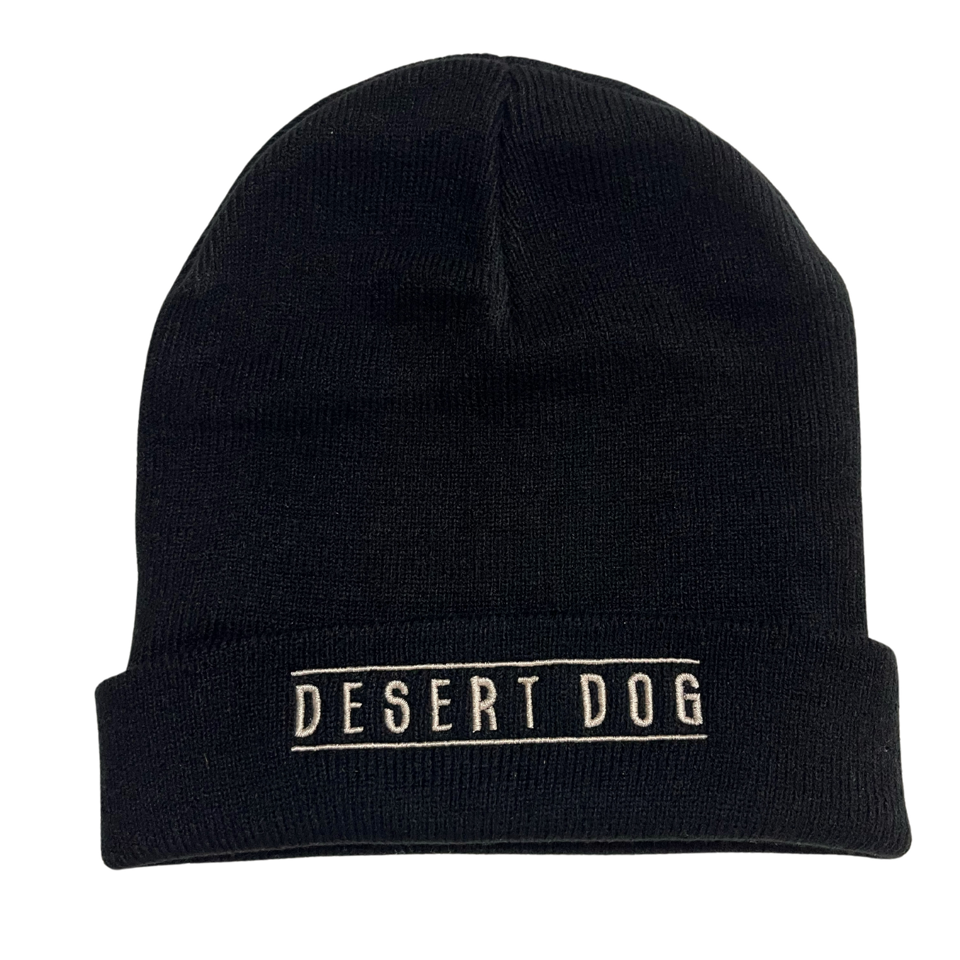 A close up photo of a black knitted beanie with the words Desert Dog embroidered on the cuff in white.