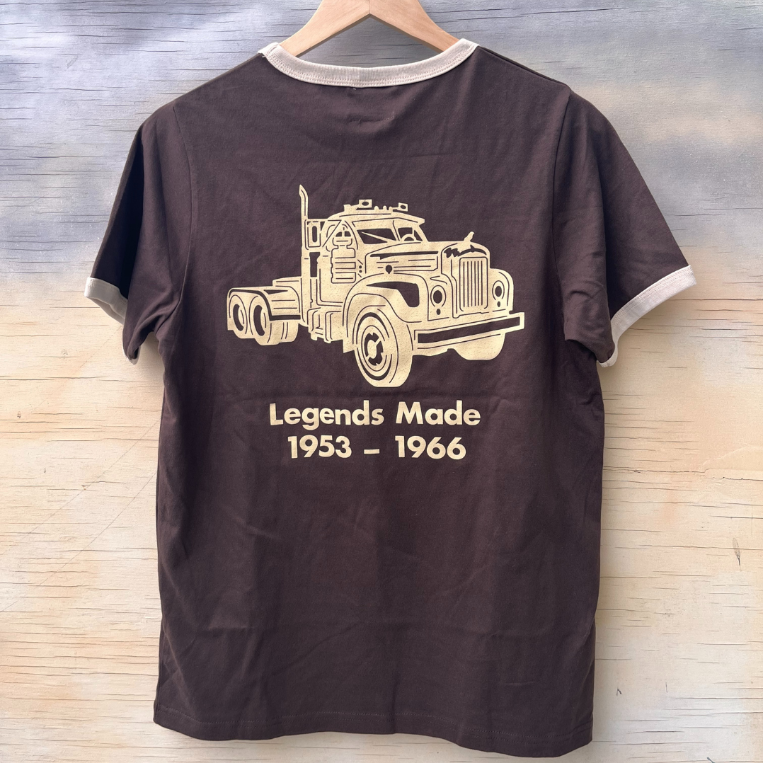 The back of a brown ringer style tshirt with cream binding and a screen printed B model Mack truck. The words "Legends Made 1953 - 1966 are under the image.