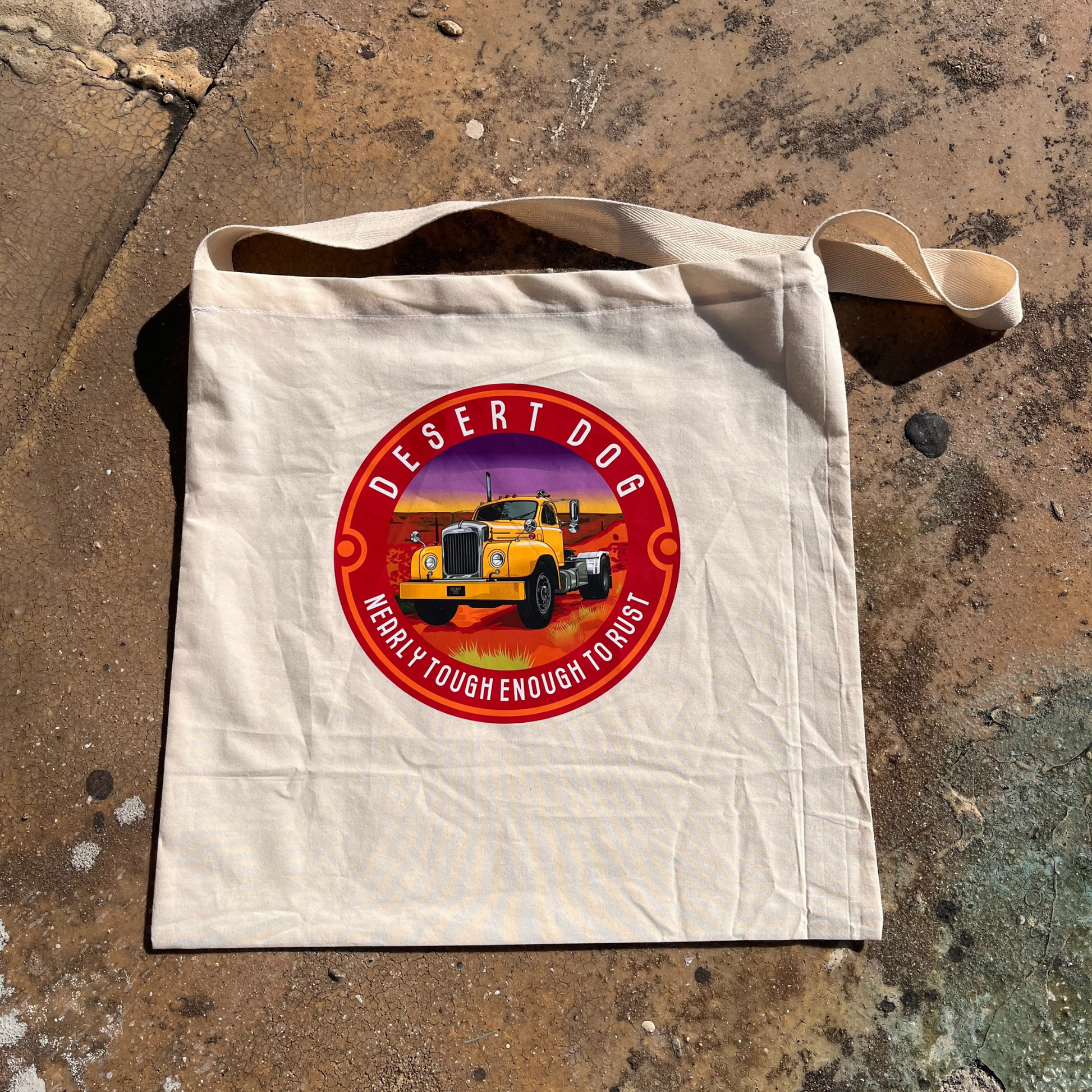 A calico tote bag with a Desert Dog logo