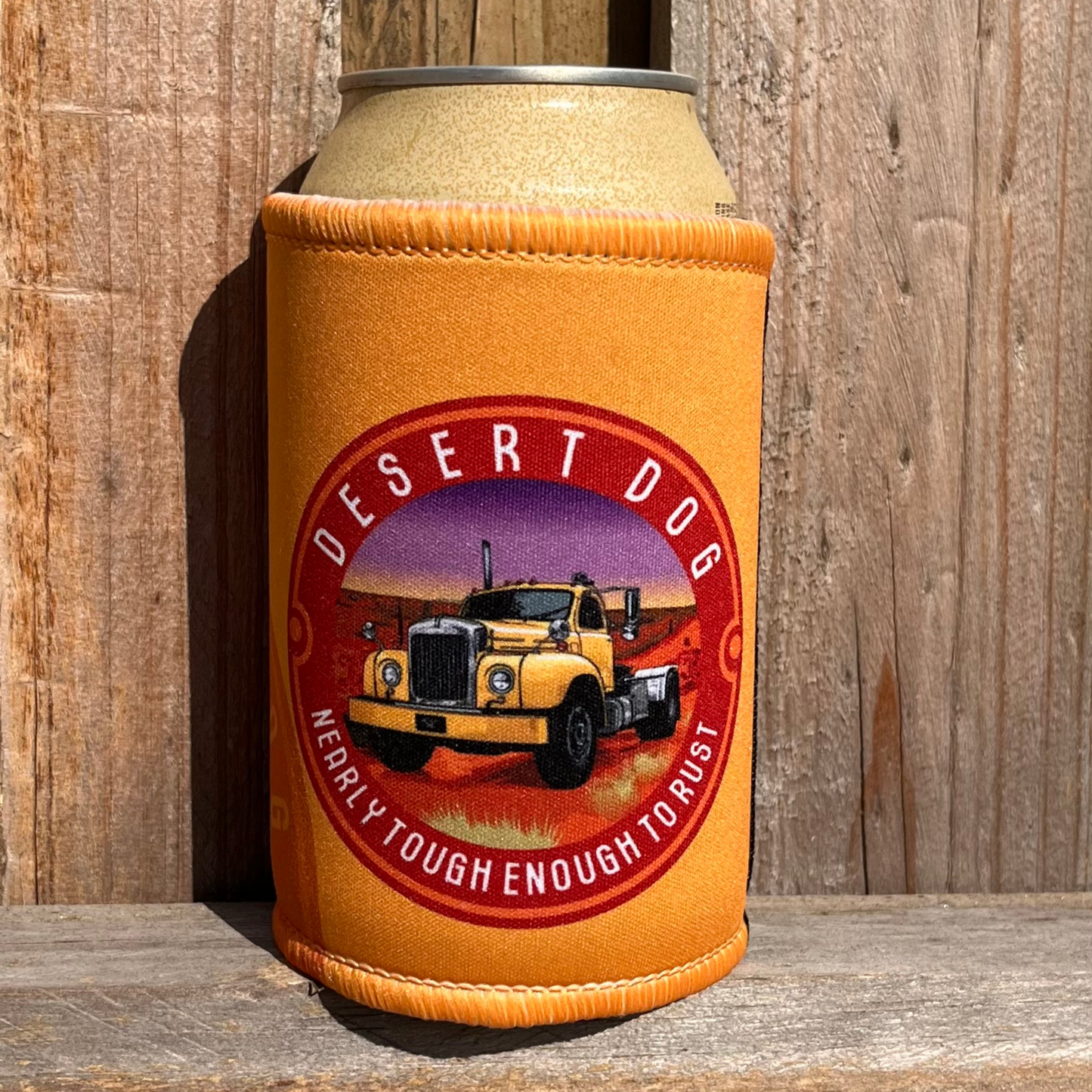 Signature yellow stubby holder with the Desert Dog logo of a B model Mack truck sitting on a wooden fence